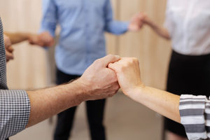 people holding hands at an anxiety treatment program