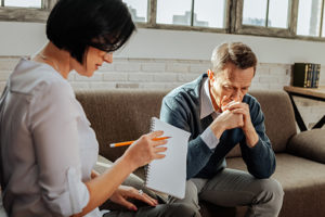 man meeting with a therapist at a bipolar treatment program